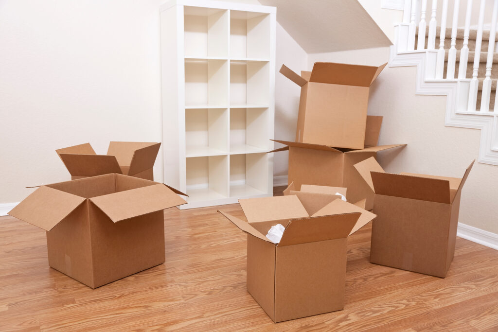 Open cardboard moving boxes in an empty home ready for packing and house removals.